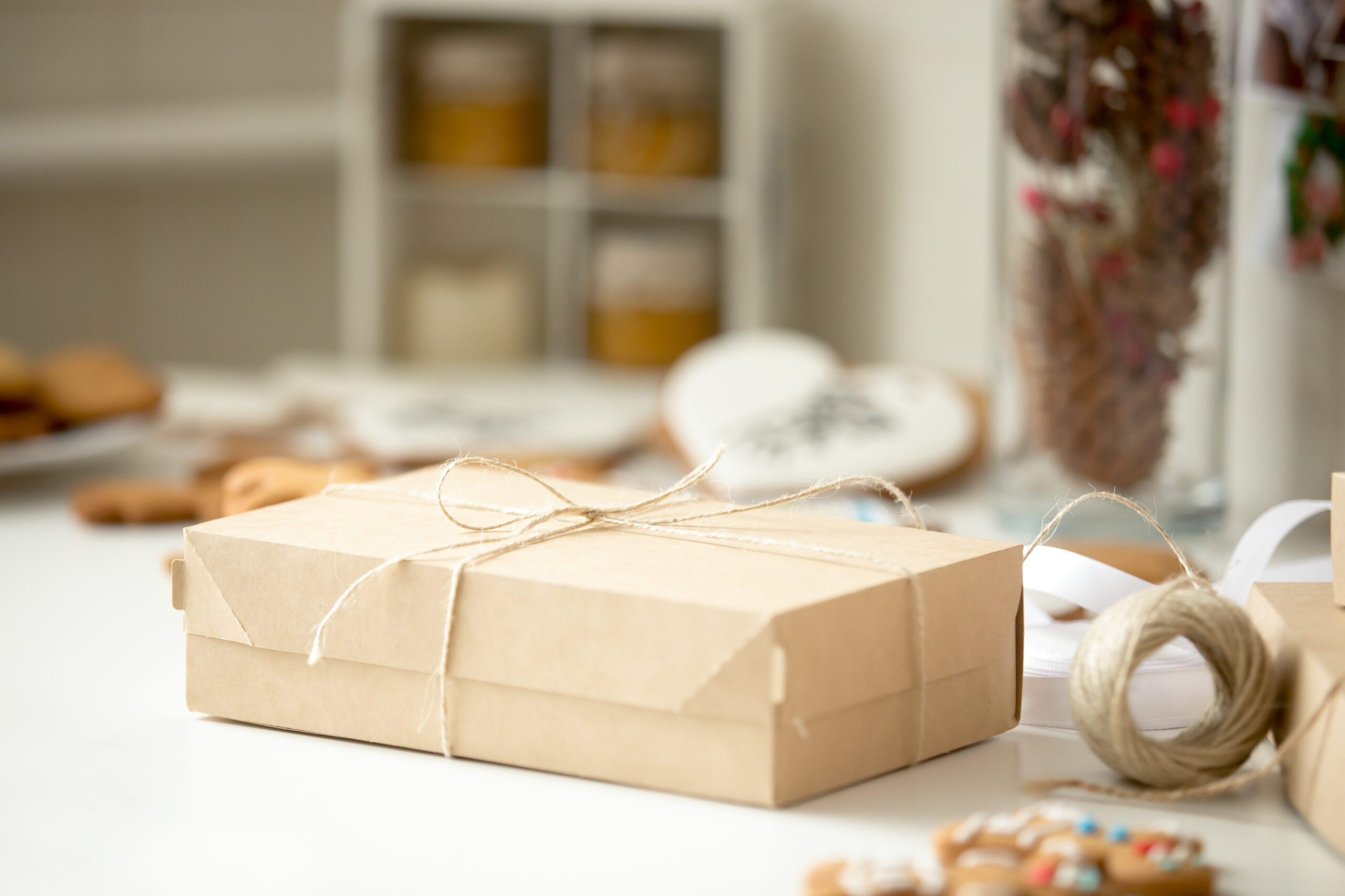 cardboard-box-postal-parcel-wrapped-brown-kraft-paper-tied-scaled