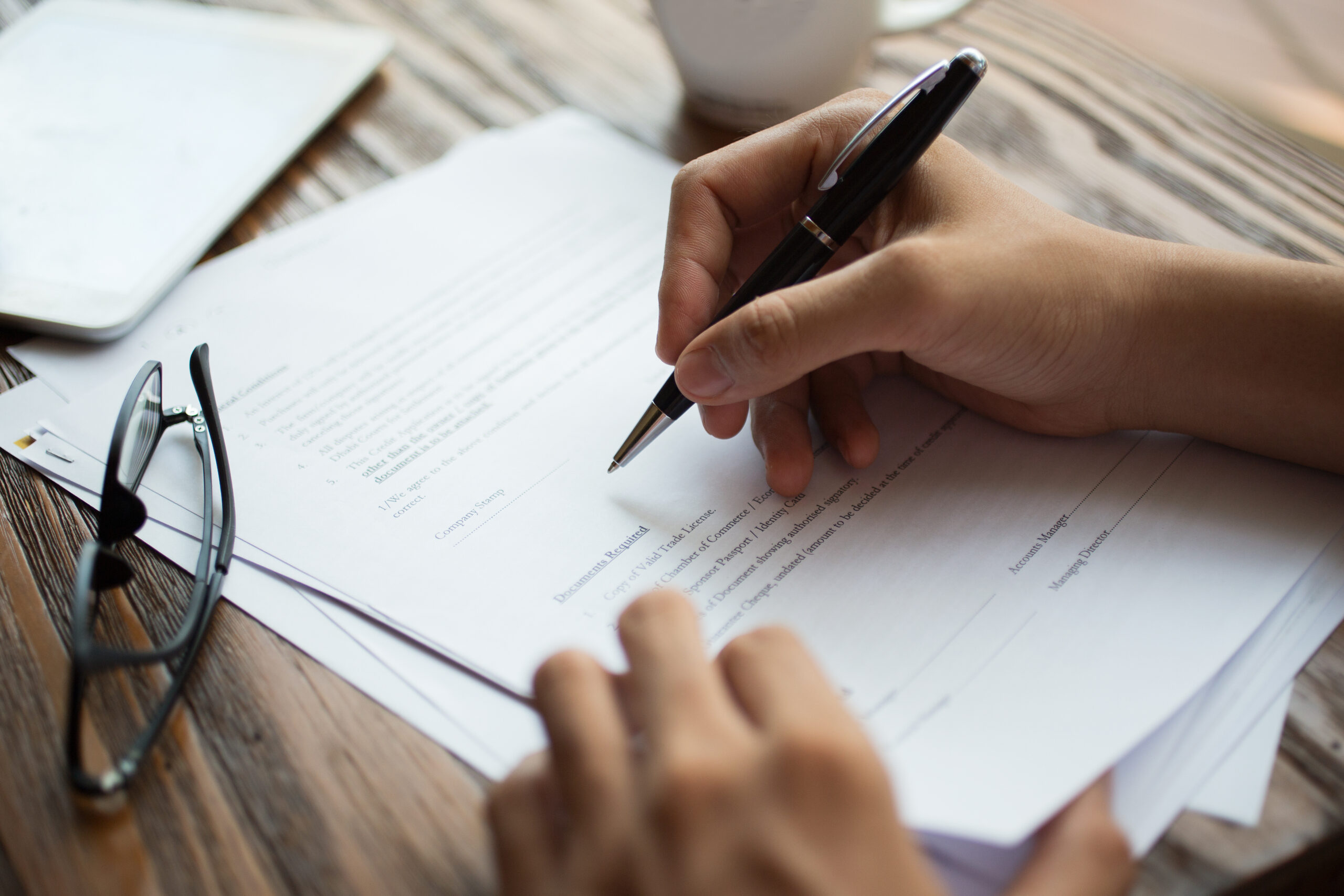 businessman-examining-papers-table-scaled